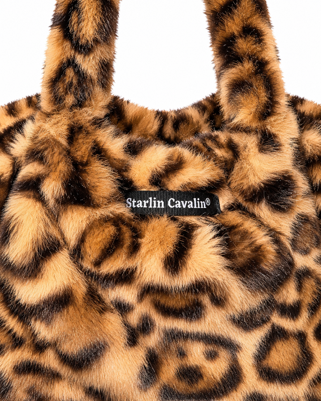     Close-up of Starlin Cavalin Leopard Muse Bag showing faux-fur leopard print and signature brand label