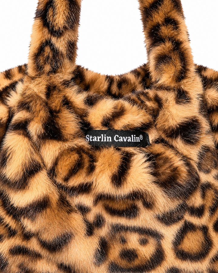    Close-up of Starlin Cavalin Leopard Muse Bag showing faux-fur leopard print and signature brand label